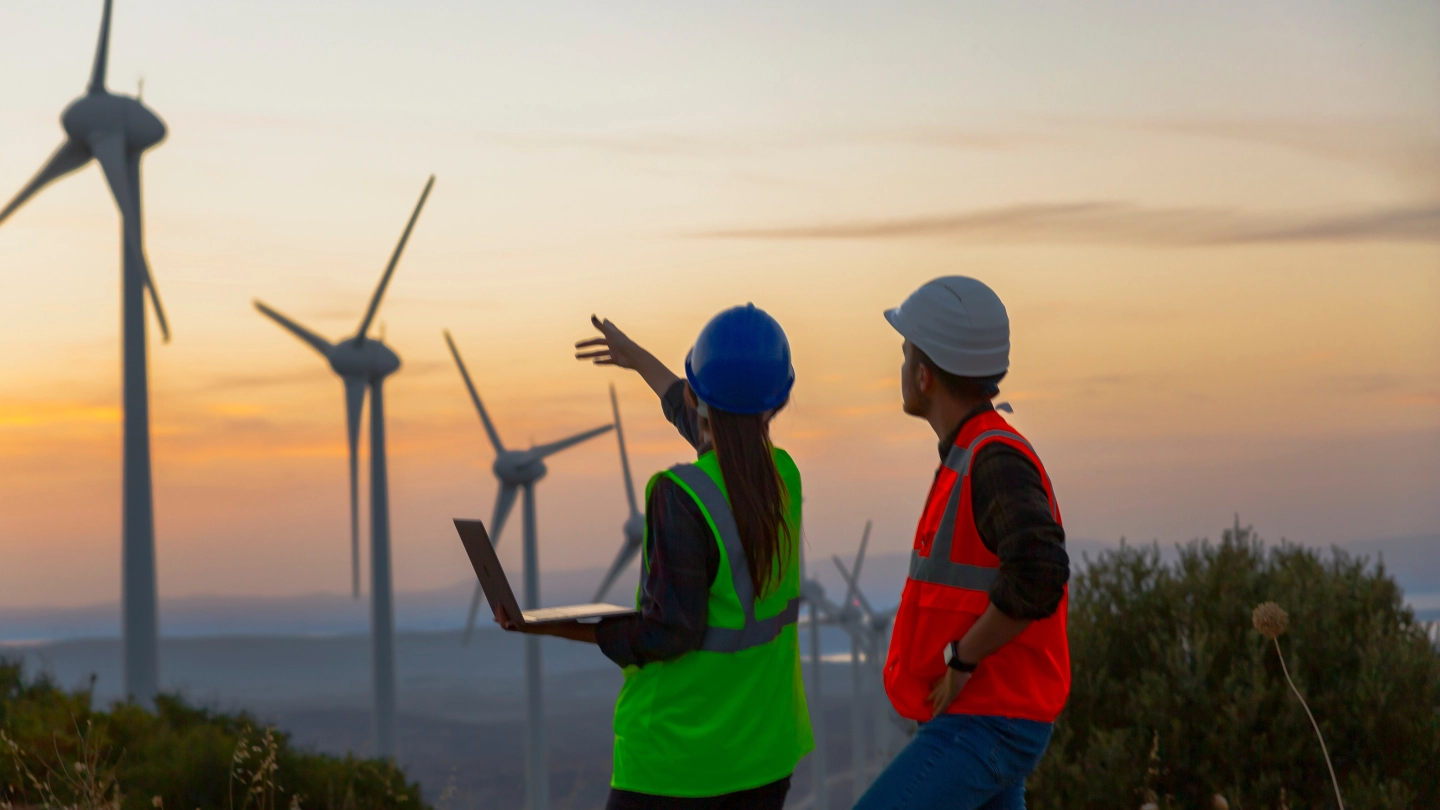 Two energy workers in front of wind turbines image